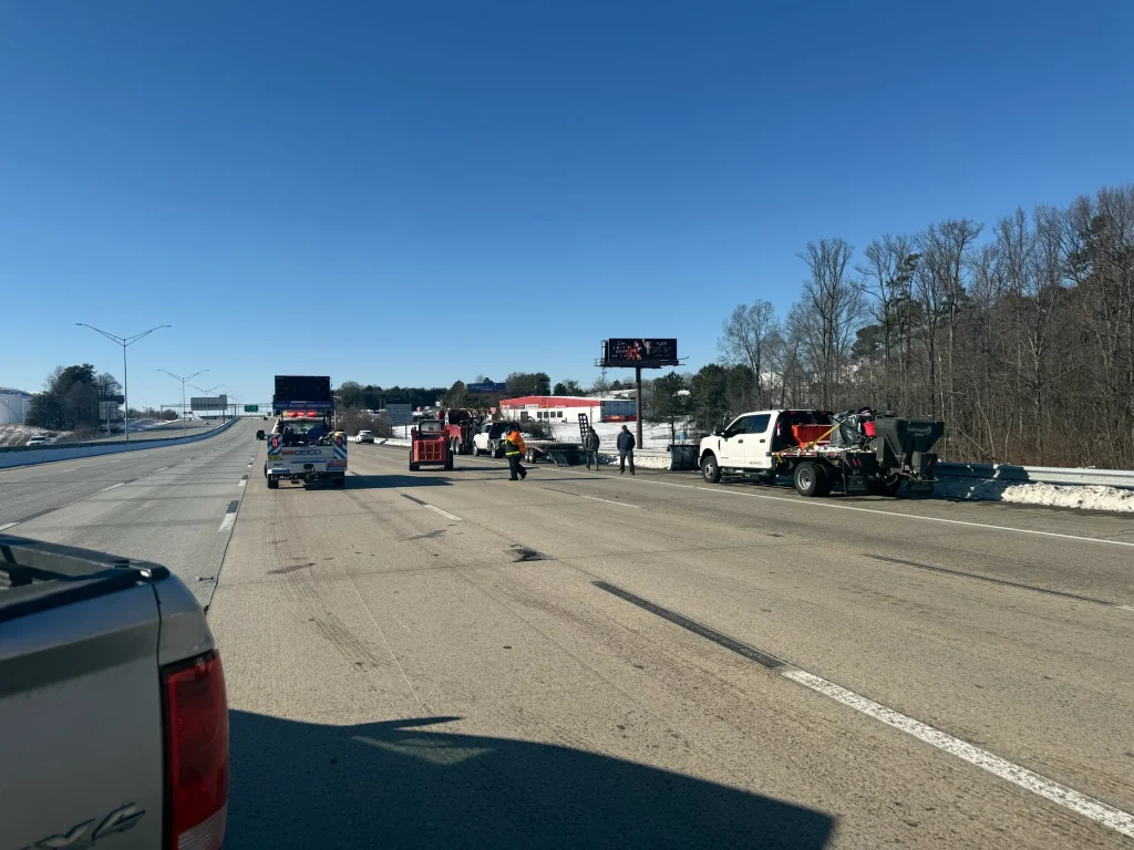 Fonvilletreeservice crew responding to highway snow and ice conditions with service vehicles and equipment on cleared roadway in NC