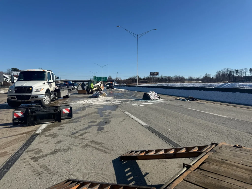 Fonvilletreeservice crew assists with highway accident debris cleanup on snow-covered interstate with tow trucks and emergency response vehicles in NC