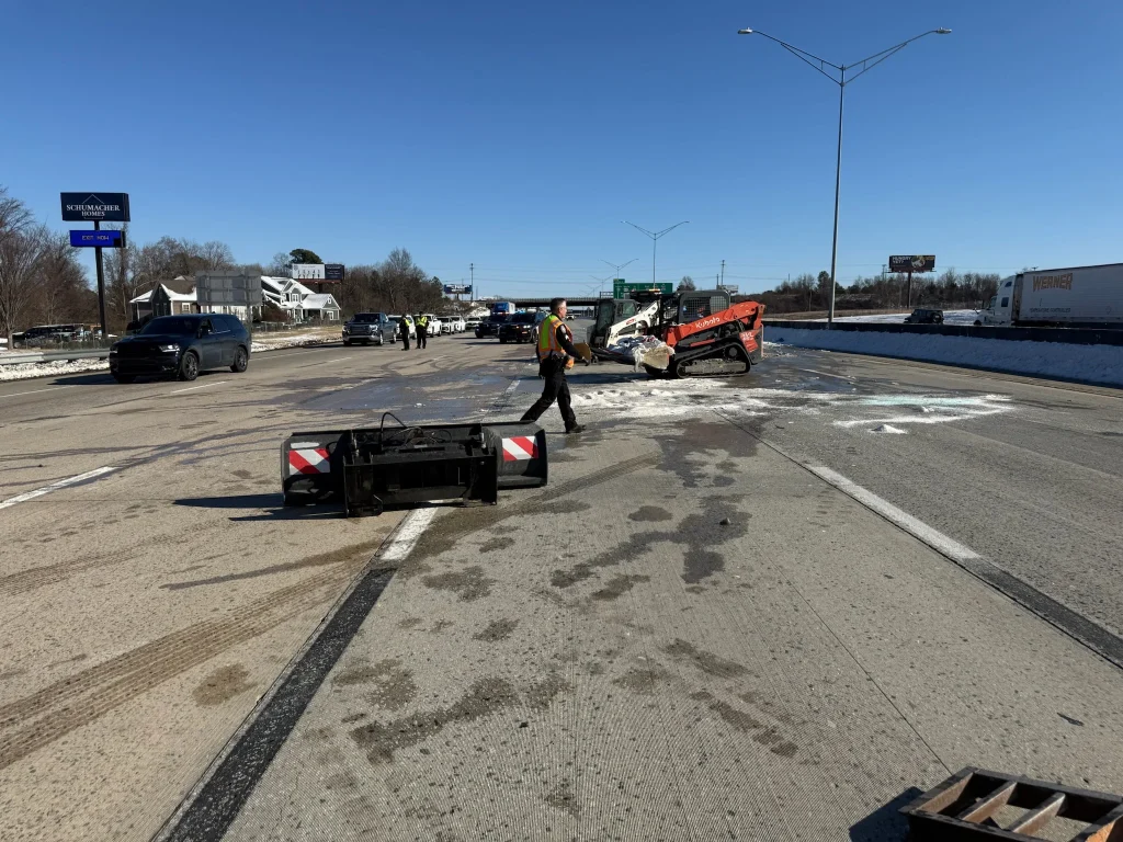 Fonvilletreeservice crew operating Kubota skid steer clearing highway debris and equipment during winter road cleanup in NC