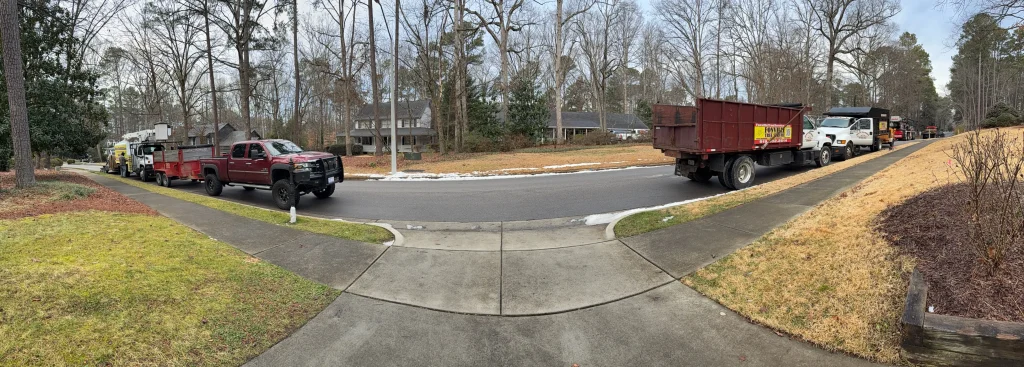 Fonvilletreeservice trucks with dump trailer and roll-off dumpster staged on residential cul-de-sac for tree work in NC