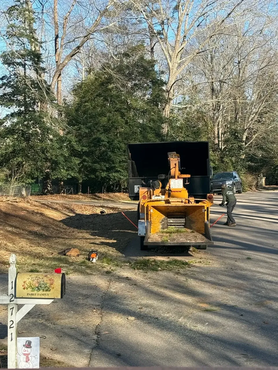 Chipper truck processing trimmed limbs
