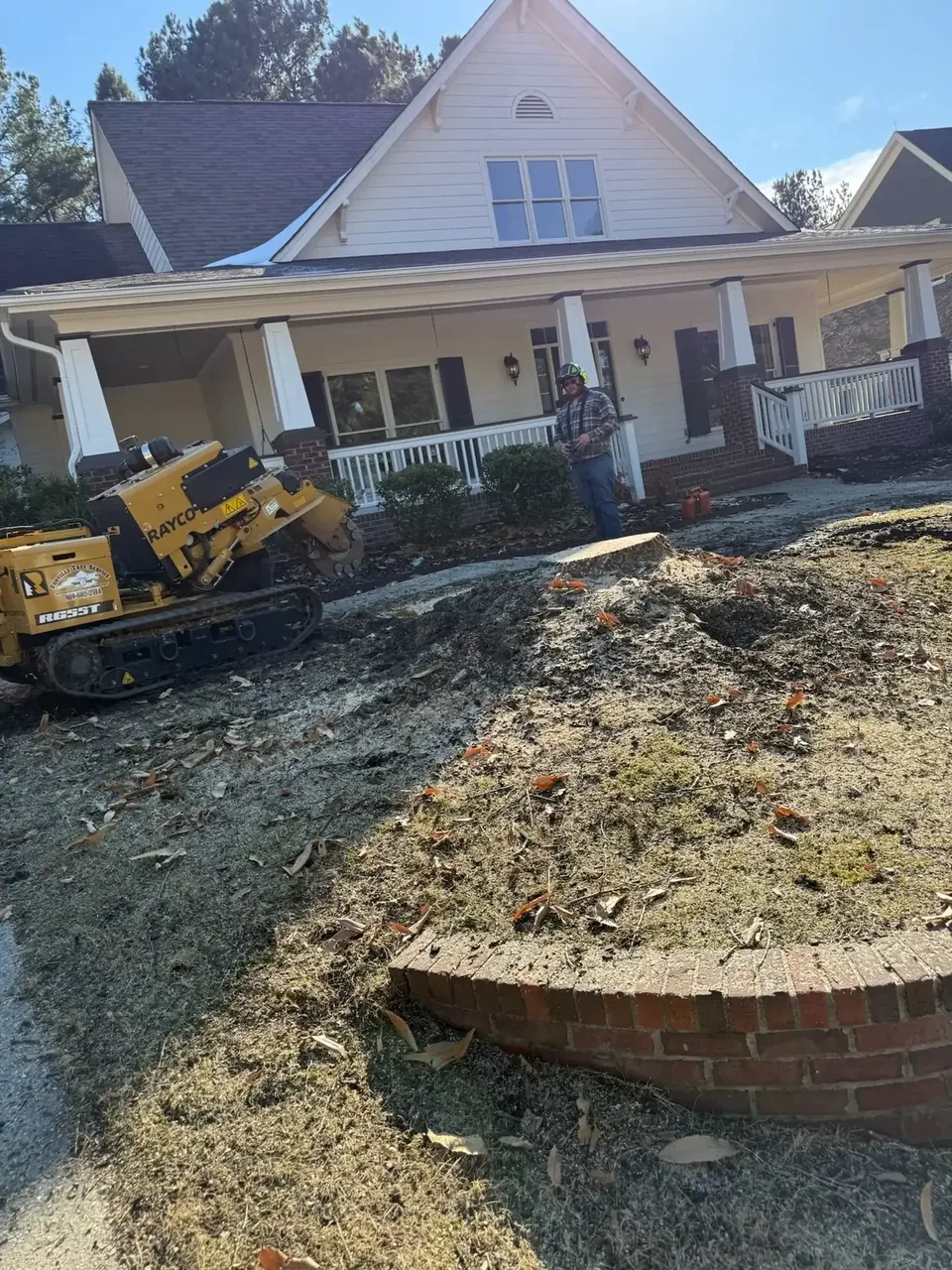 Stump grinder finishing a stump in a front yard